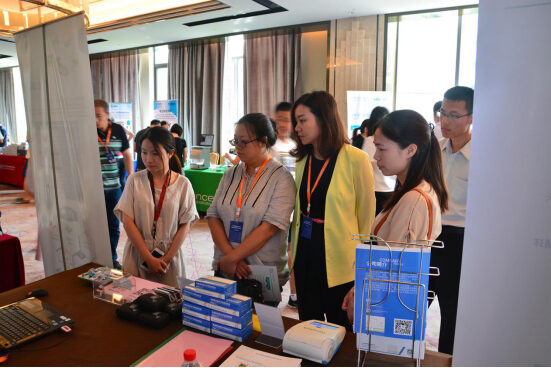 Visitors at an exhibition stand viewing reagent kits