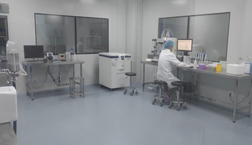 Molecular laboratory with benches, instruments and a researcher at a workstation